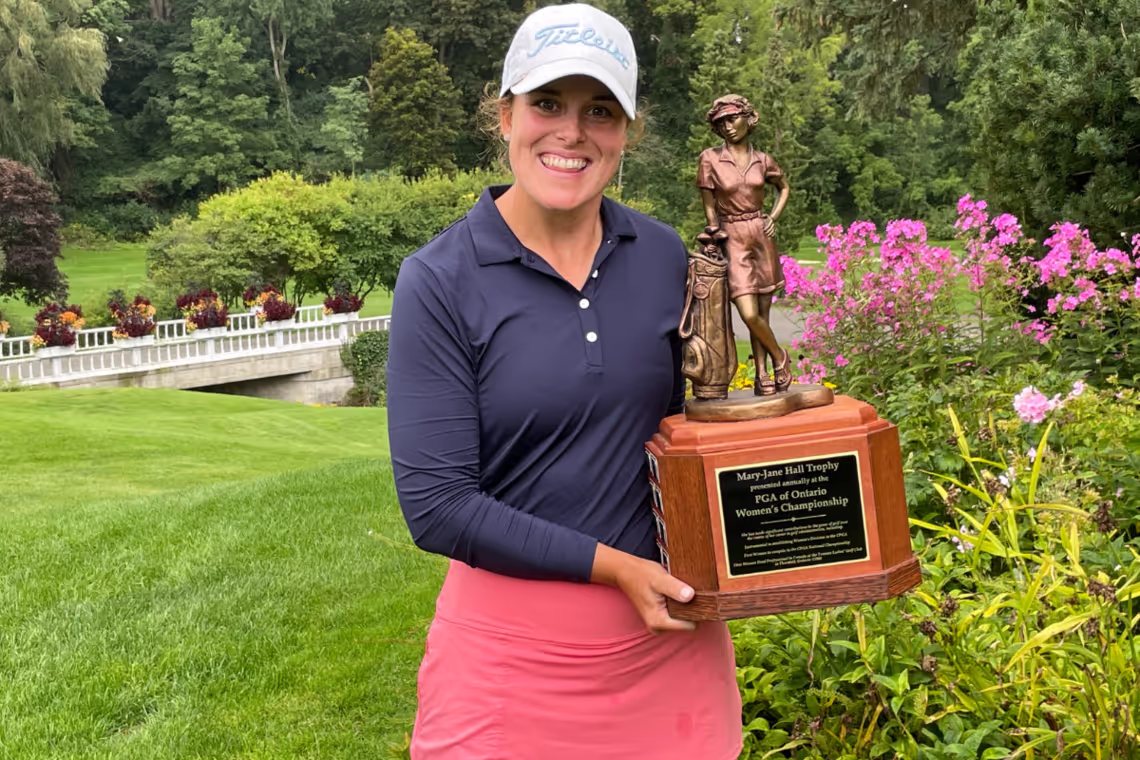 Coach Natalie Gleadall holds a trophy from the PGA of Ontario Women's Championship.