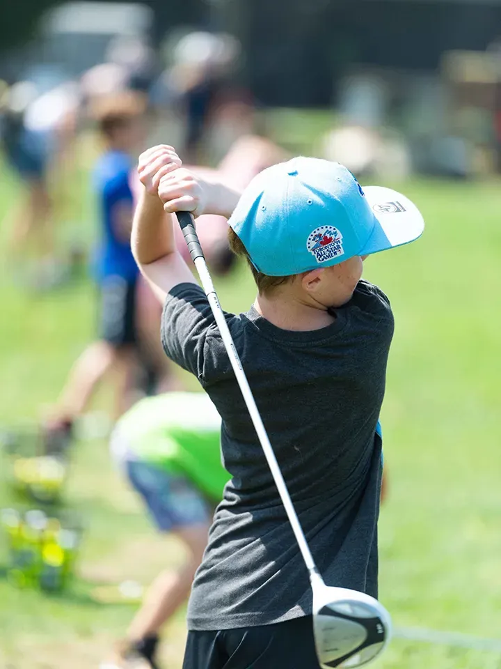 A man finishes his swing at the Market Sports driving range.