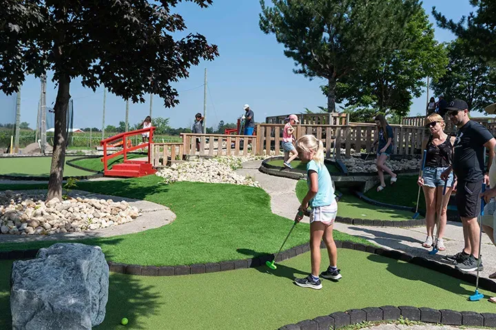A family plays mini golf at Market Sports.